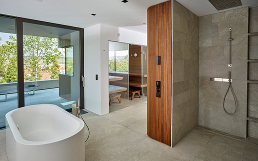 Privé-wellnessruimte: Gecoördineerde materialen in de hele wellnessruimte: Naast de sauna vindt u ook een elegante regendouche en een vrijstaand bad.